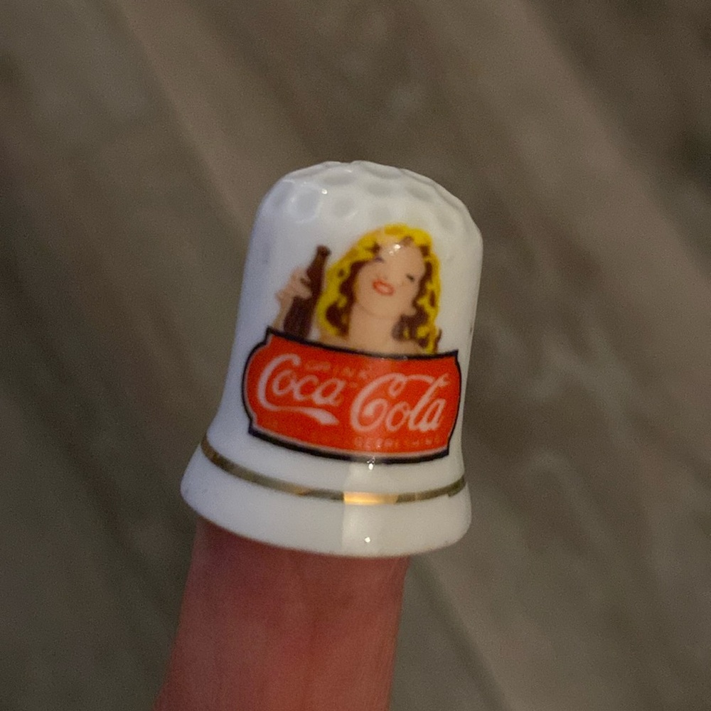 Vintage Coca-Cola Ceramic Sewing Thimble
Girl Advertising Bottle of Coke